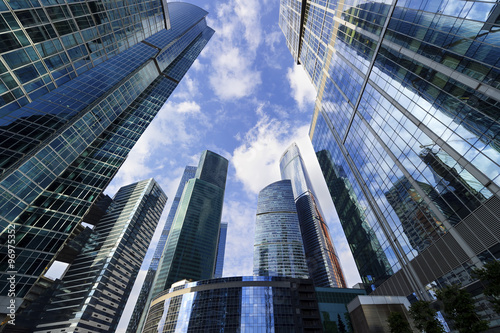 Fotografie, Obraz Modern business office skyscrapers, looking up at high-rise buildings in commerc