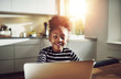 © Flamingo Images - Cute young black girl playing on a laptop