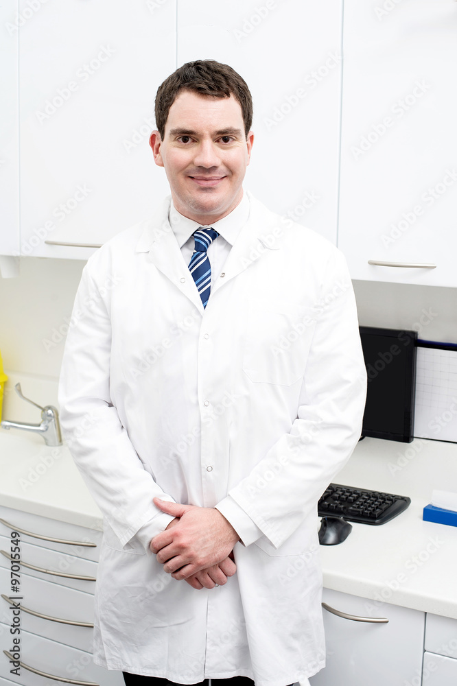 Smiling male doctor posing in lab coat Stock Photo | Adobe Stock