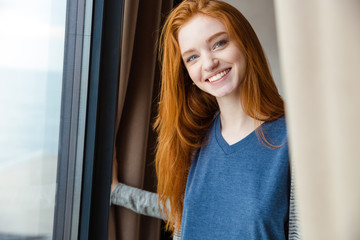 Poster - cheerful pretty girl with red hair looking camera and smiling