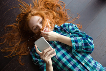 Canvas Print - funny amusing girl playing with hair and listening to music