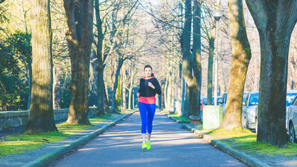  Beautiful young woman jogging alone at park