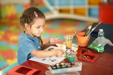 Little girl drawing at home