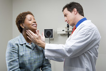 Doctor Checking Womans Throat