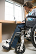 © xixinxing - Disabled woman using a laptop computer