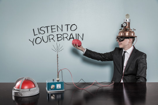Listen to your brain concept with businessman holding brain