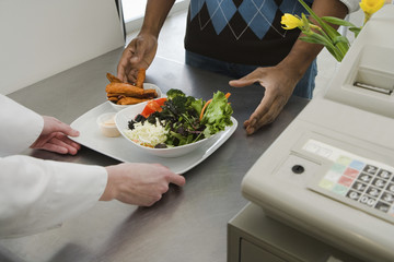 Man buying meal in cafe