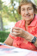 Senior adult woman drinking tea