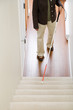 © xixinxing - Blind woman using a walking stick on stairway