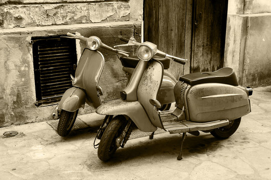 Two vintage scooter parked in the street