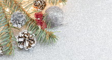 Pine Cones And Christmas Decorations On Sparkling Background