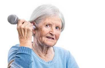 Wall Mural - Elderly woman holding microphone close to an ear. Hearing problems.