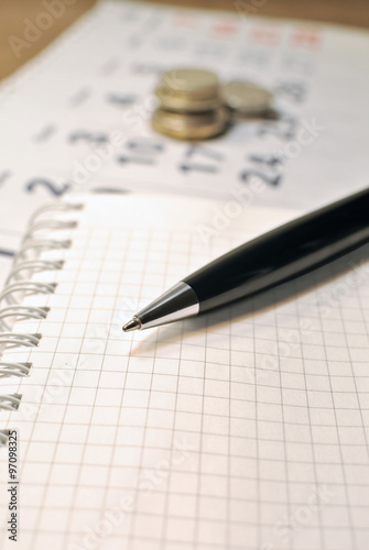 calculating expenses concept pen calendar notebook and calculating expenses