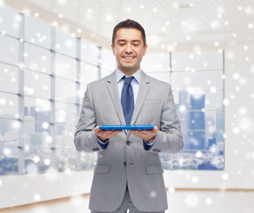 Poster - happy businessman in suit holding tablet pc