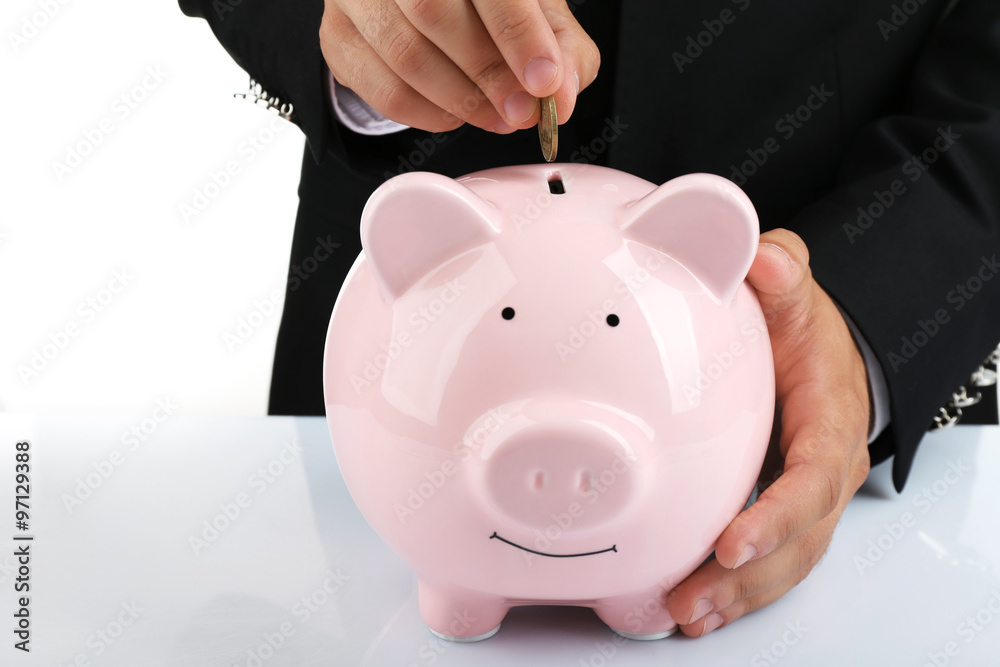 Man put coin into a piggy-bank