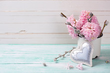 Background  With Hyacinths,  Willow Flowers  In Aged Mug And Decorative  Heart On Turquoise Painted Wooden Planks Against White Wall. Selective Focus And Empty Place  For Your Text.