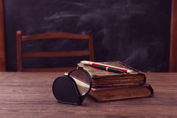 Poster - Books and school accessories on wooden table