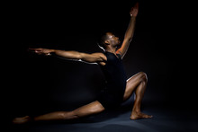 Black Male Dancer Practicing Warm Up Exercises For Flexibility