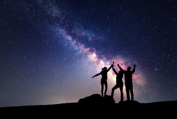 Wall Mural - Milky Way. Night sky and silhouette of a family