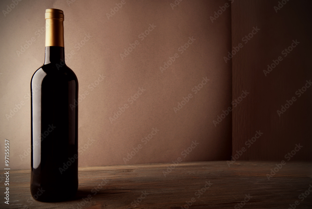 Bottle of red wine on wooden table