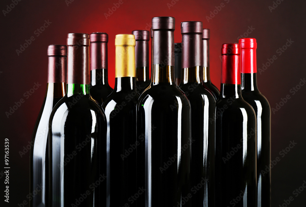 Wine bottles on red background