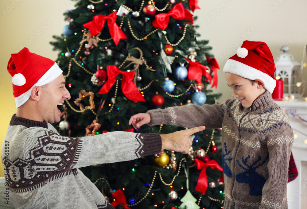 Father and son on Christmas interior background