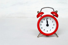Red Vintage Alarm Clock Striking Midnight Or Midday