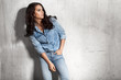 © deniskomarov - Latin woman in jeans and a denim shirt