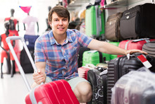 Man Choosing Suitcase At The Store.