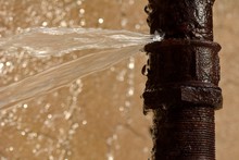 Rusty Burst Pipe Squirting Water At High Pressure