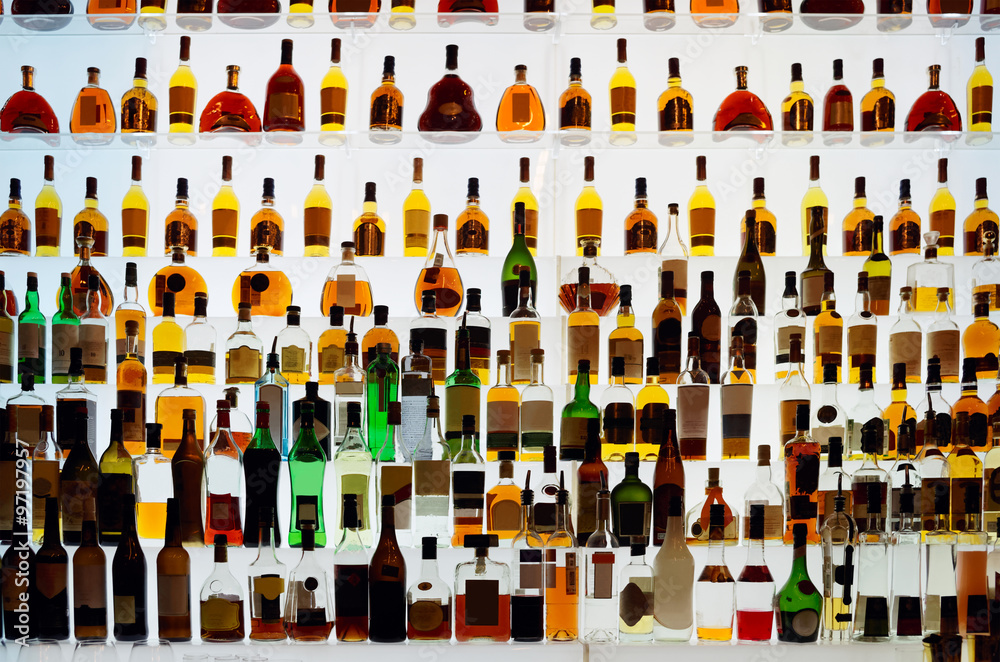 Various alcohol bottles in a bar - obrazy, fototapety, plakaty 