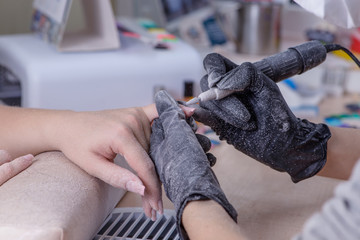 closeup of manicurist at work in the salon nail (shallow DOF; co