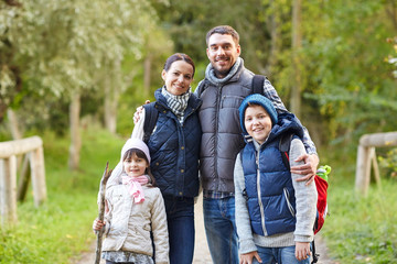 Wall Mural - happy family with backpacks hiking