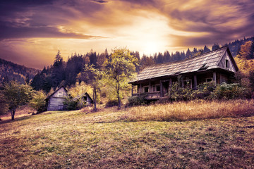 Wall Mural - abandoned wooden house on hillside under dramatic sky