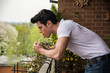 © theartofphoto - Handsome young man smoking a cigarette outside