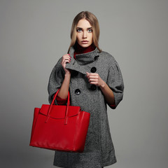 winter beautiful woman with handbag.fashion girl in topcoat.shopping