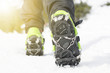 © tibor13 - Hiking boots with equipment for ice. Snow like a background and sun. Sun is shining. Moutains and travel.