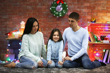 Happy family in the decorated Christmas room