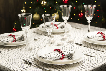 Christmas dinner table. Traditional Christmas decorations. Served table in a restaurant. Beautifully set table for Christmas Eve.