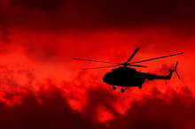 Helicopter On A Background Of Fire Sky