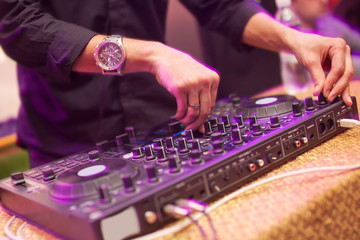 Wall Mural - DJ mixing music on console at the night club