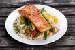 Pan fried salmon with tender asparagus and courgette served on couscous mixed with sweet tomato, yellow pepper salsa.