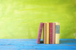 row of books, free copy space on green background
