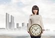 © asierromero - portrait of a pretty young woman holding a big clock