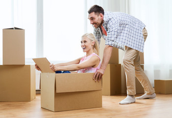 Poster - couple with cardboard boxes having fun at new home