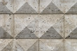 Old ashlar wall made of dolomite rock carved in geometrical pattern
