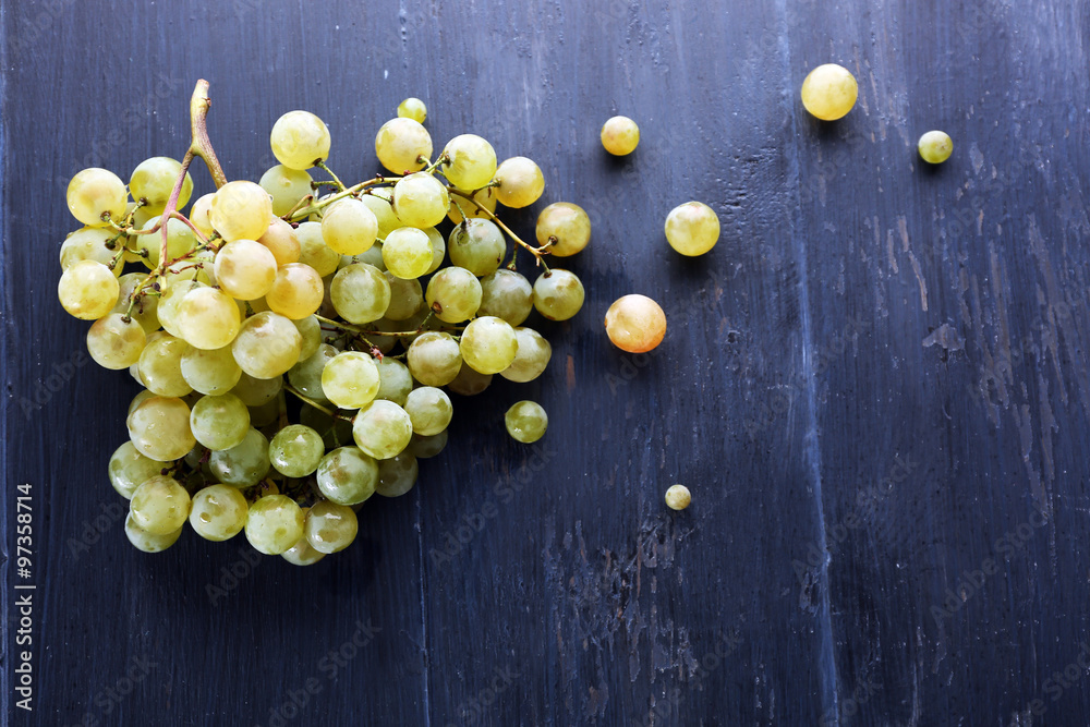 Juicy green grapes, on wooden background