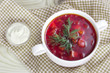White bowl with red traditional borsch.Beetroot soup upper view.
