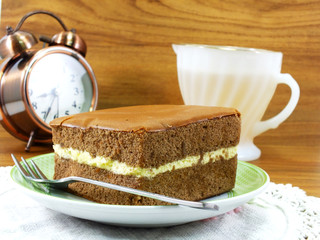 Sticker - delicious soft cake chocolate flavor with cup of tea on wooden table