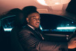 © ysbrandcosijn - Hispanic businessman inside car at night.